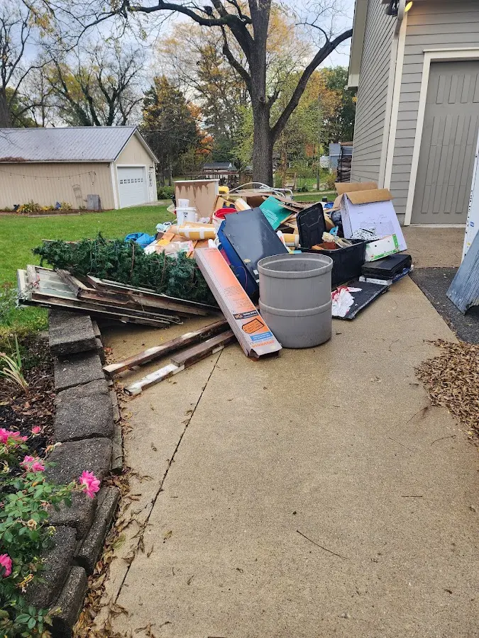 Dumpster being loaded with debris for Roofing Dumpster Rental in Stuarts Draft